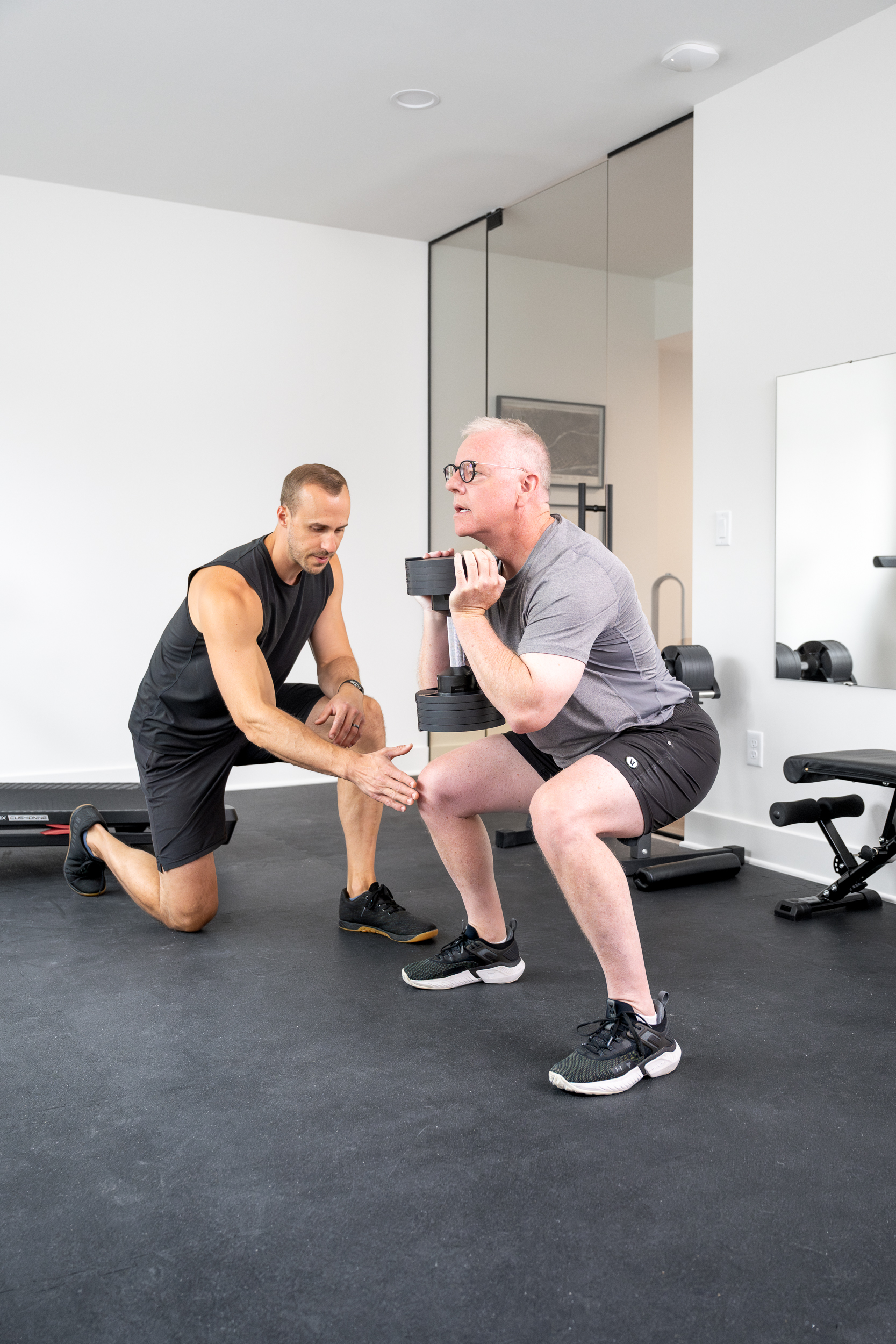 Personal trainer working with client